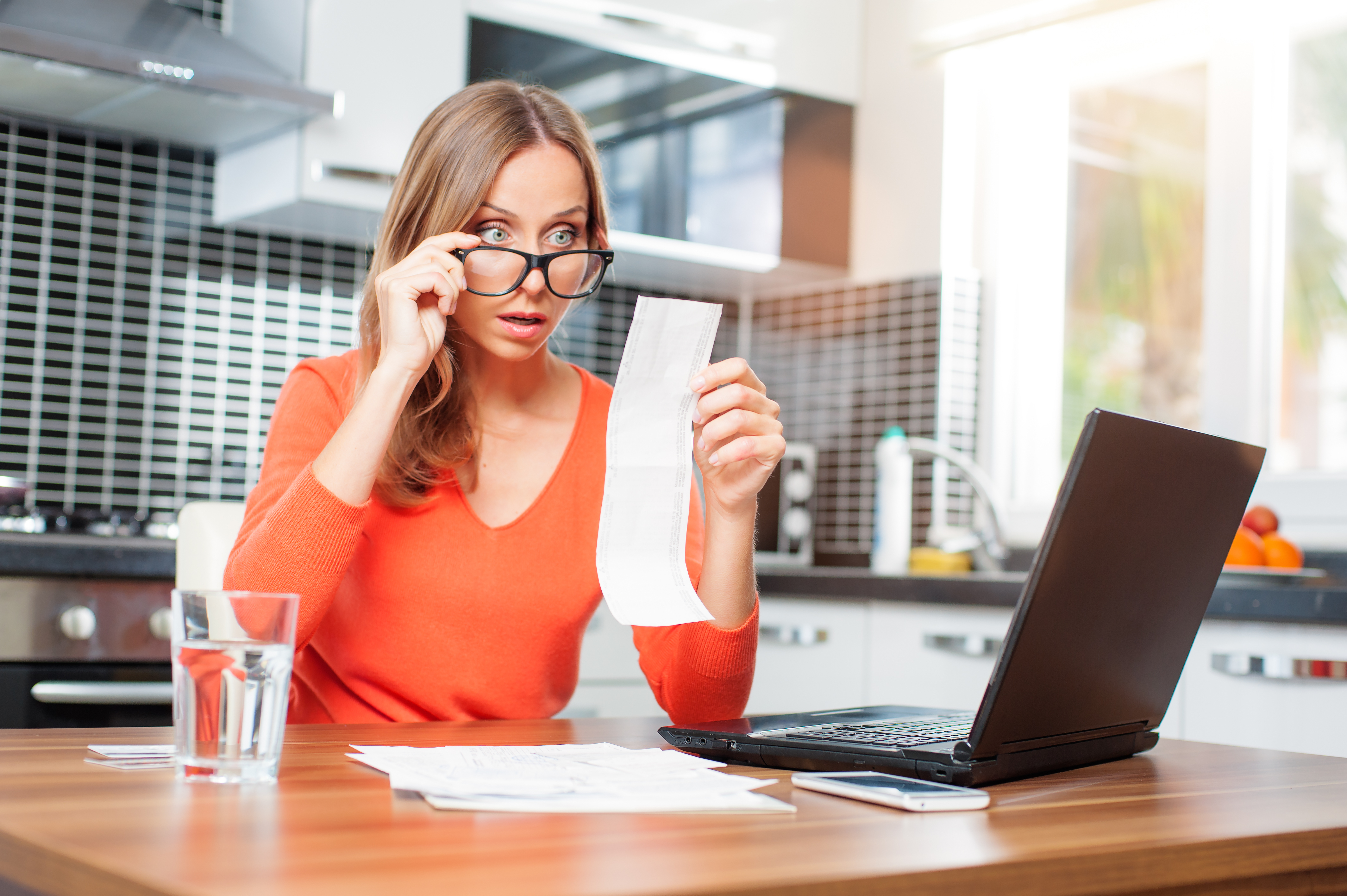 woman looking at bill computer, glasses (debt)