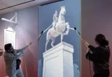 Visitors pull on ropes to topple king’s statue on screen